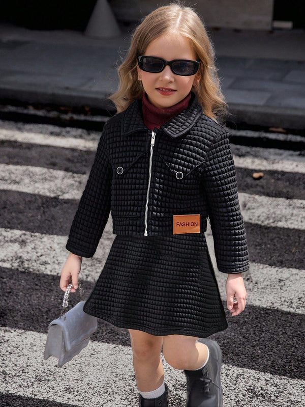 Vintage Patch Outfit: Black Patch Jacket With Gold Buttons, Turtleneck Sweater, And Pleated Patch Skirt